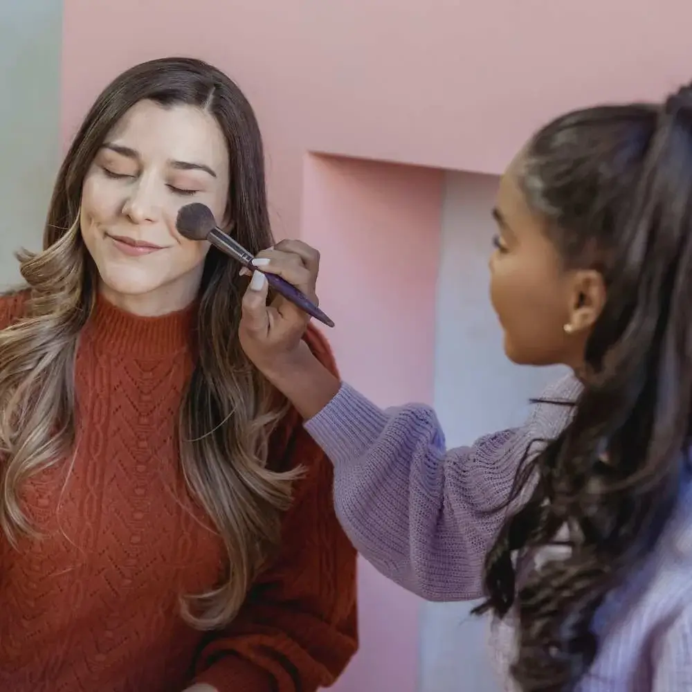 Woman applying perfectly matched foundation to her unique skin tone