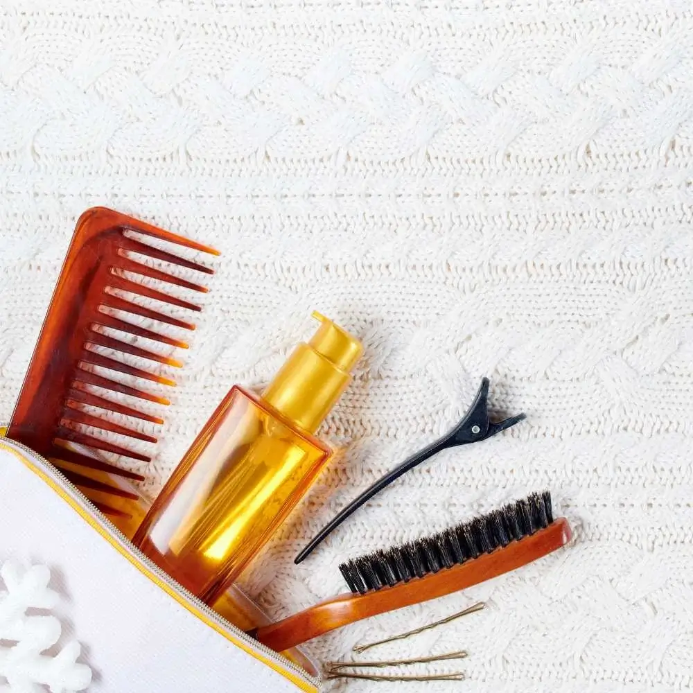 neatly packing a hair brush into a travel toiletry bag