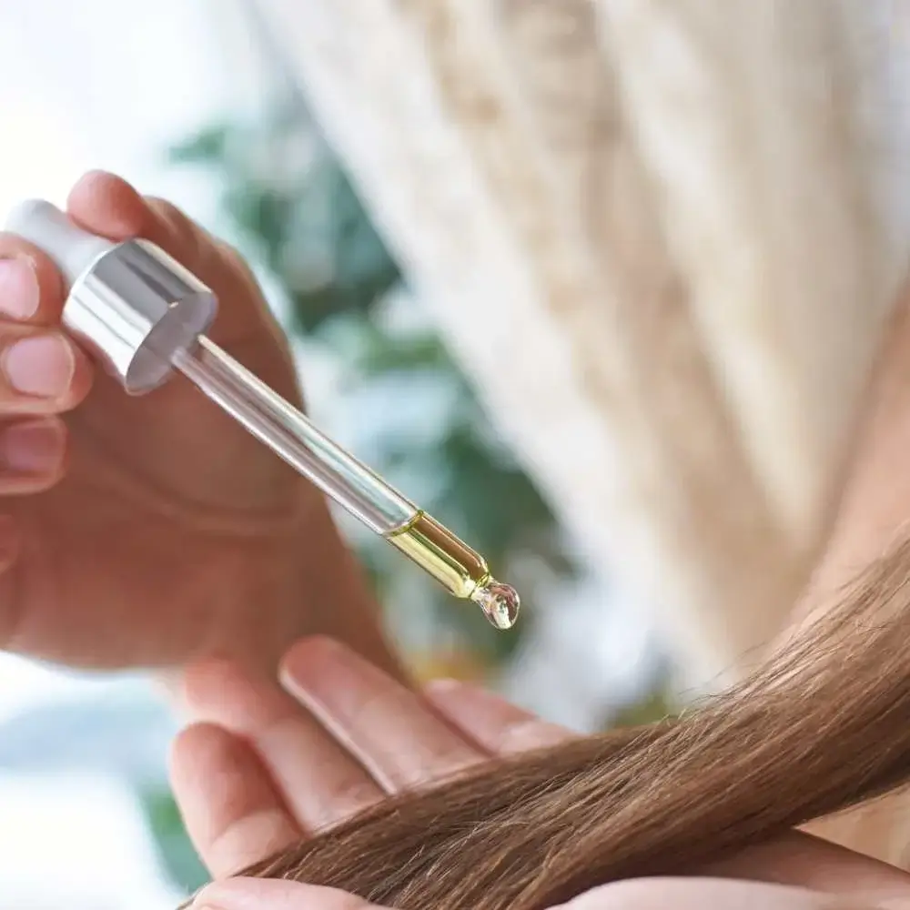 Close-up of argan oil bottle with a drop revealing its rich texture