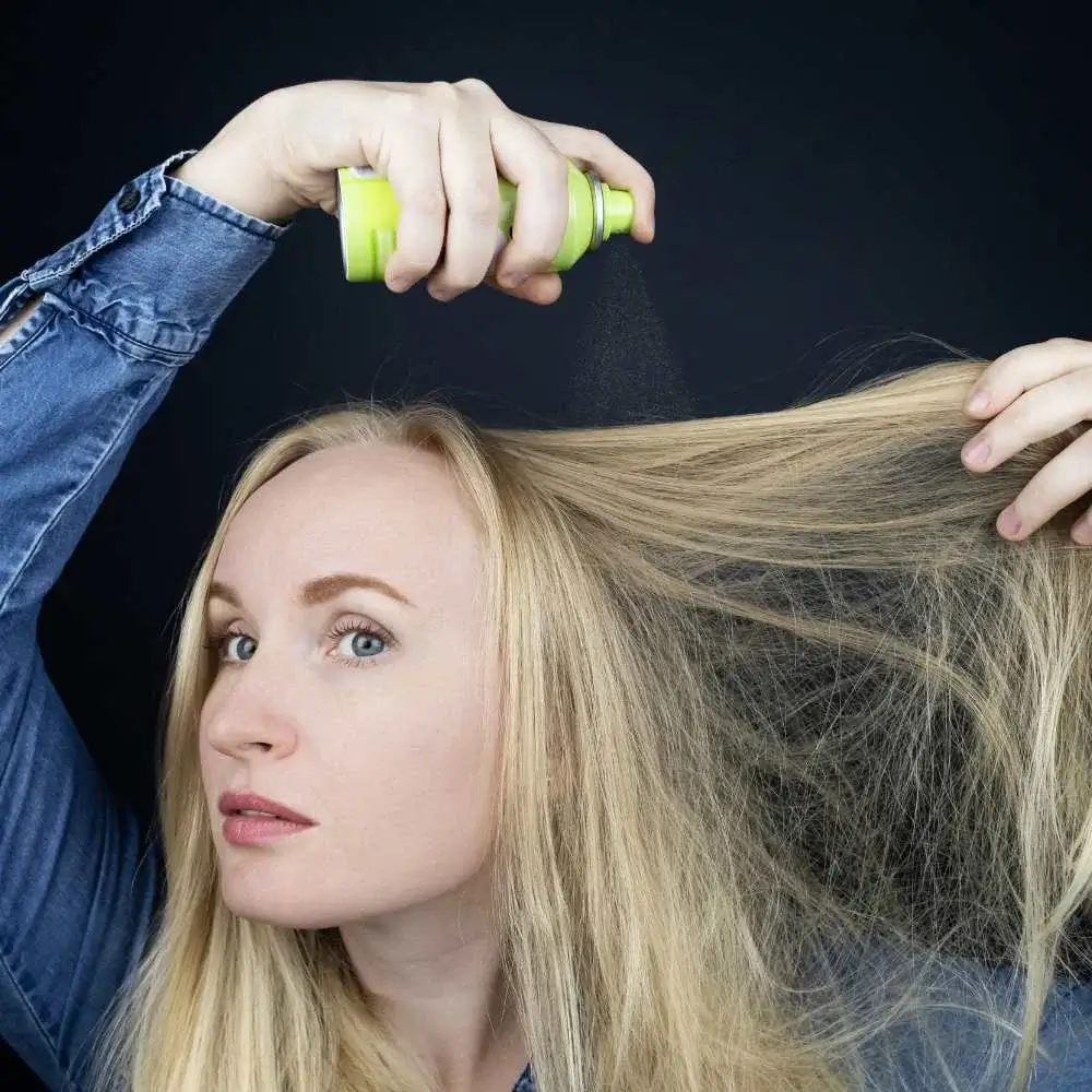 Dry shampoo particles dispersing into strands of hair