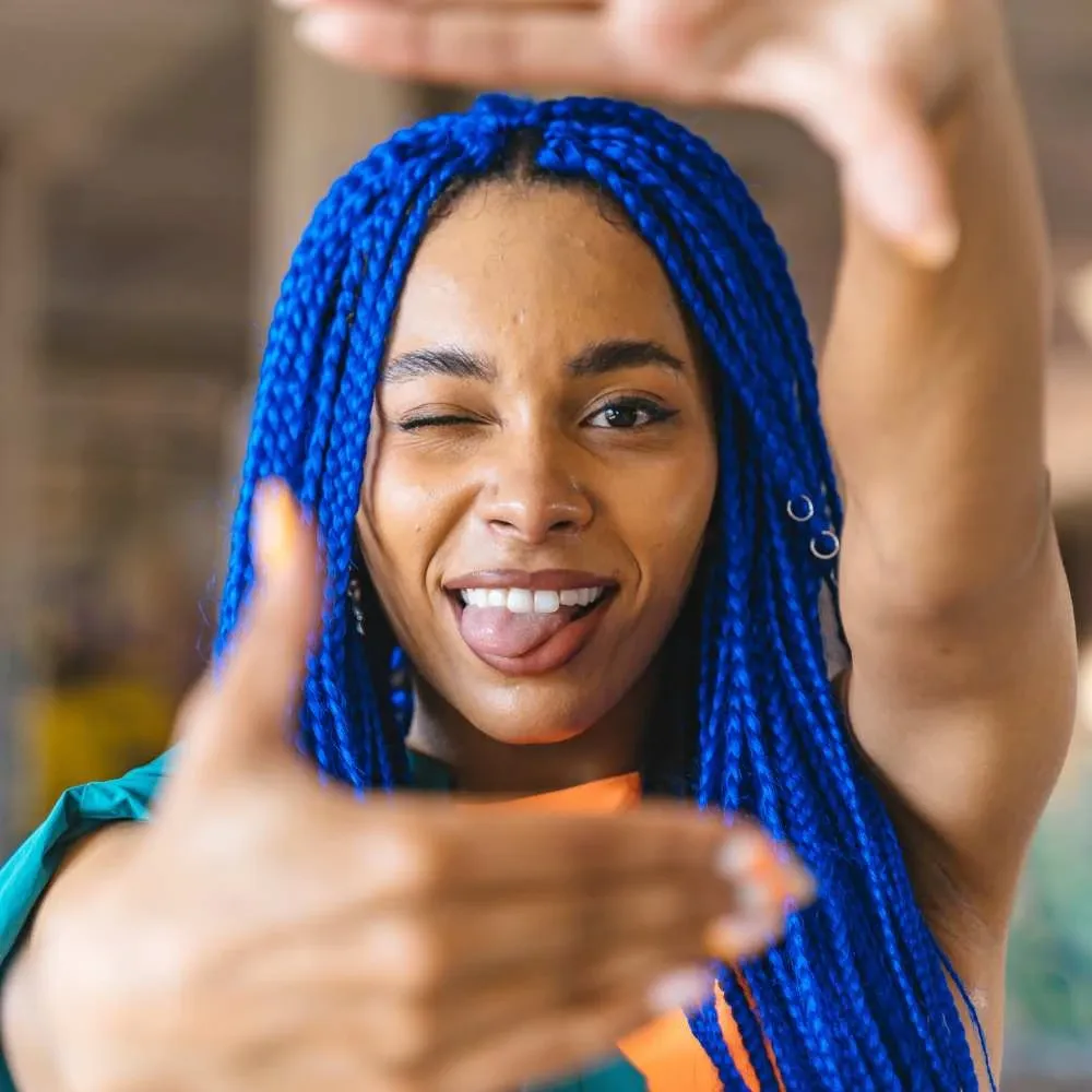 Woman with colored hair looking satisfied after using the best dry shampoo