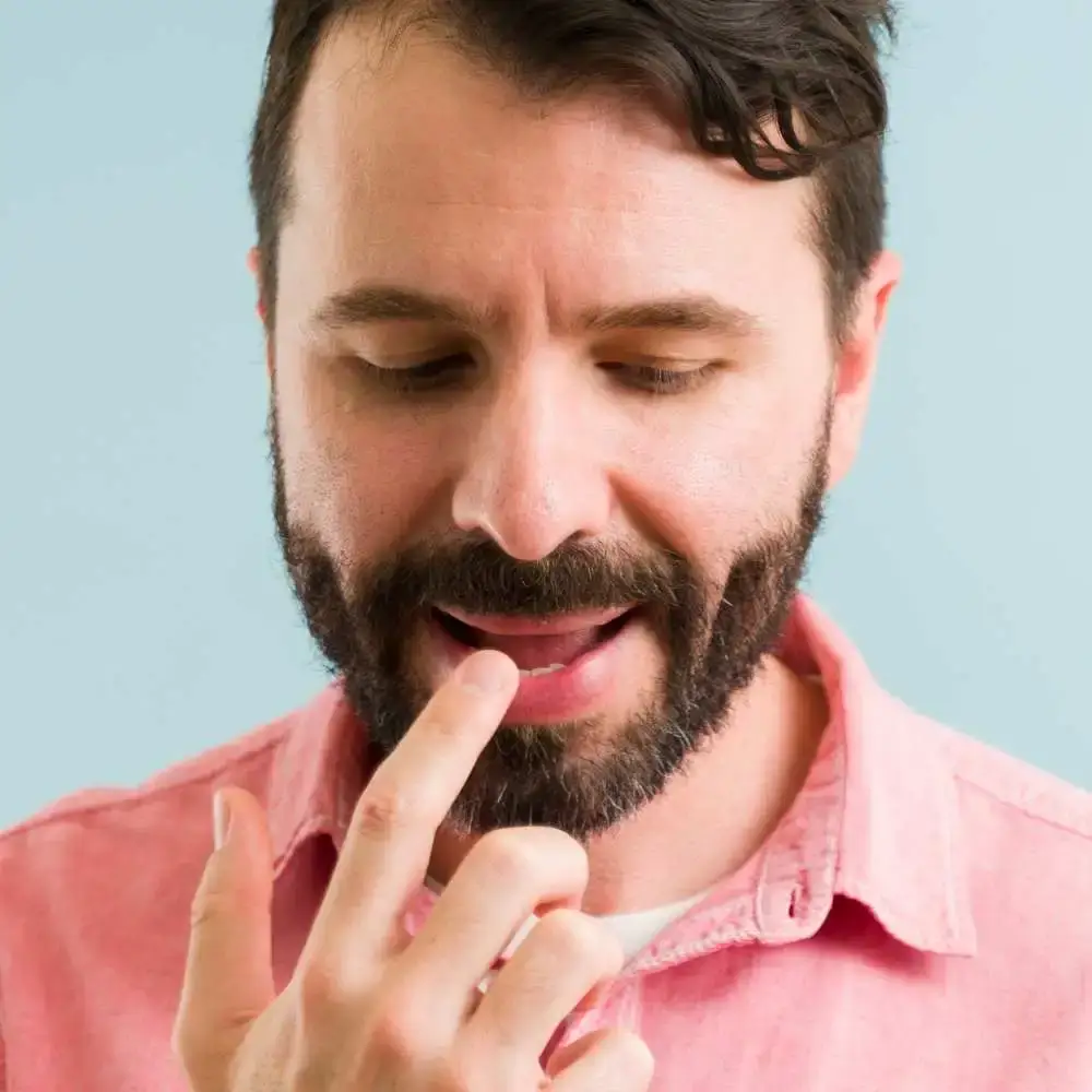 Man refreshing his lips with a swipe of hydrating lip balm