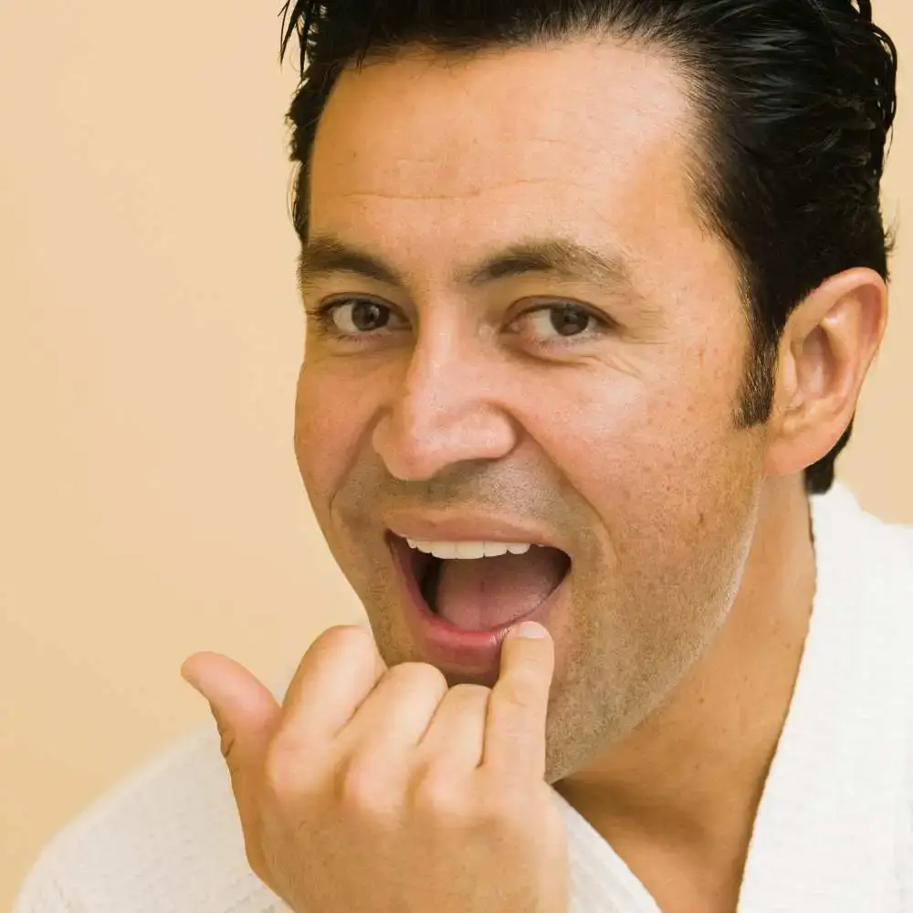 Man applying lip balm over dry, chapped lips for his comfort