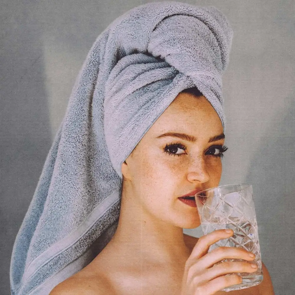 Woman smiling with clear skin, attributing her success to the best face wash for blackheads