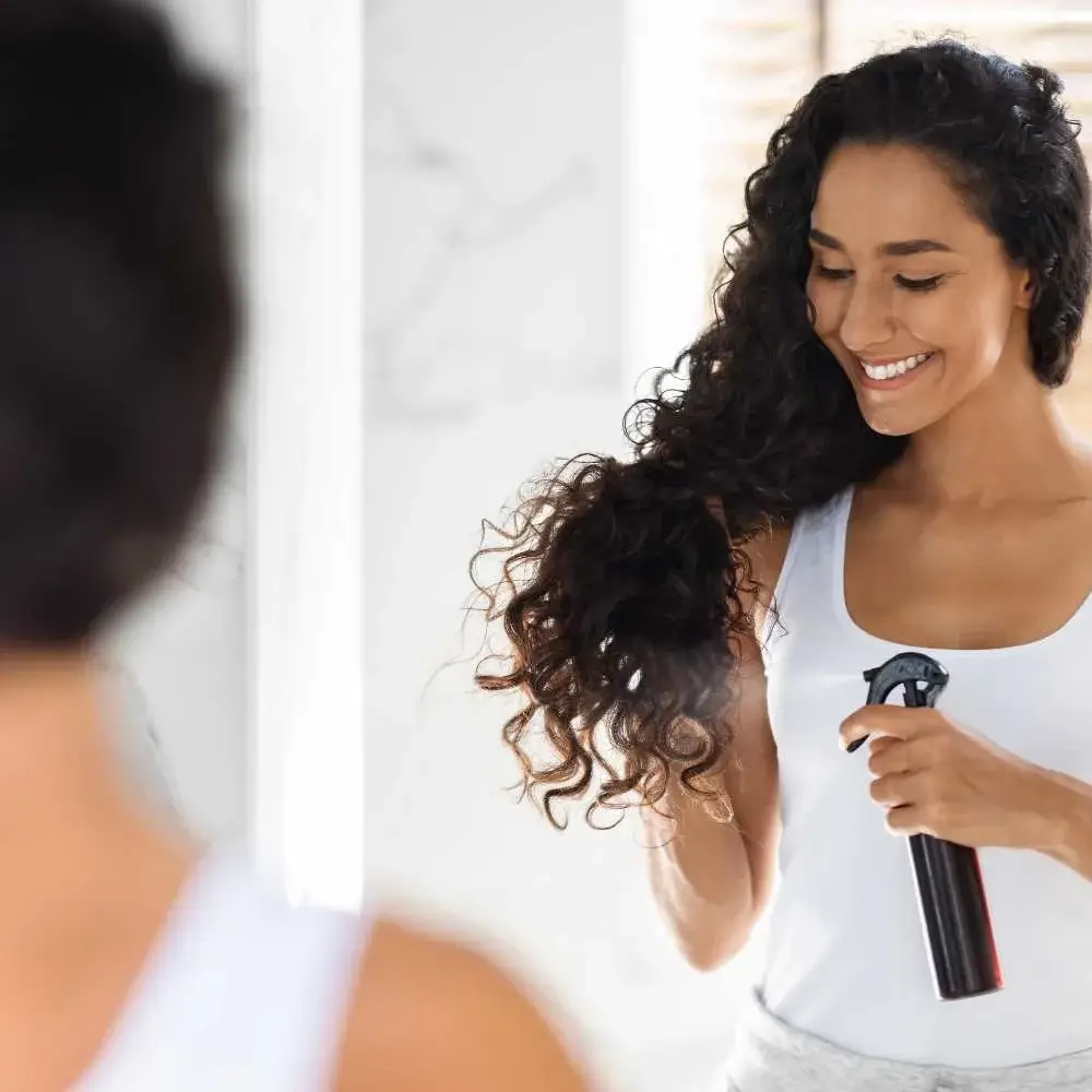 Person using a hair spray bottle