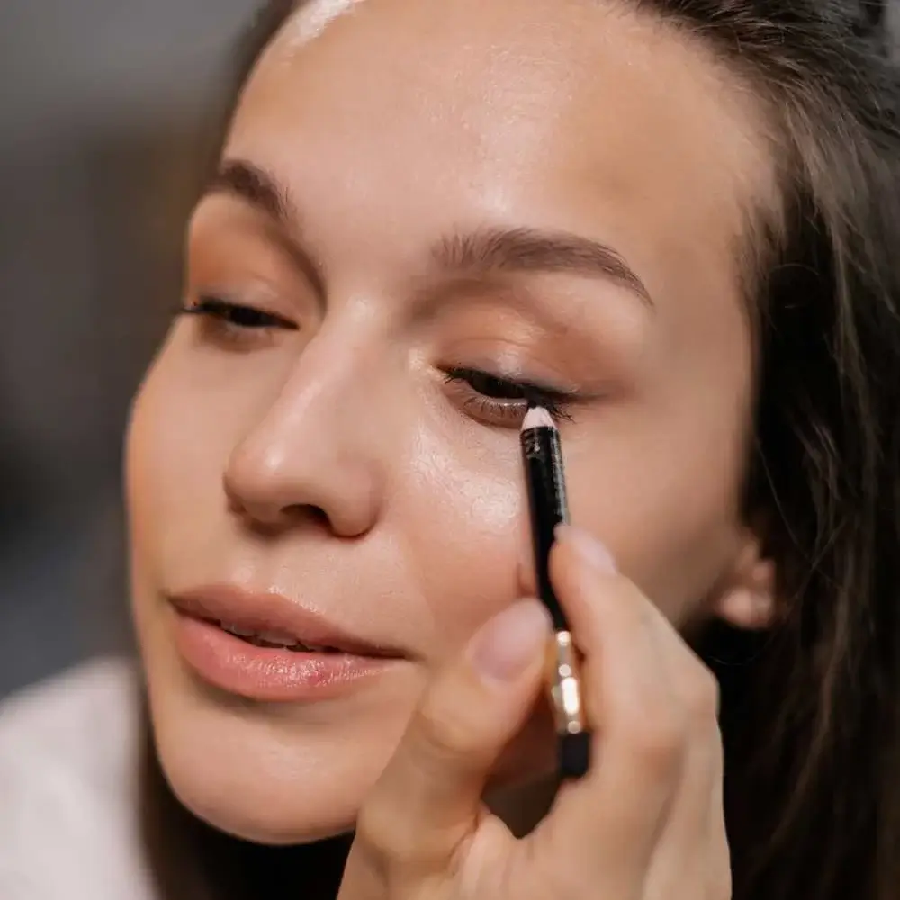 Applying water-activated eyeliner to create a bold look