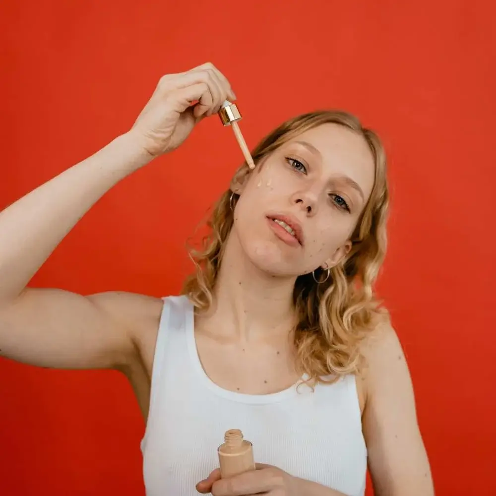 demonstrating how to apply concealer like a pro