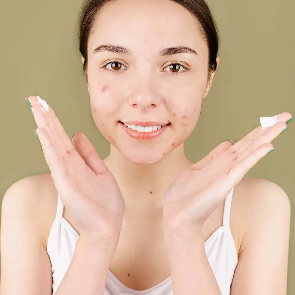 applying primer to create a smooth canvas, even on acne-prone skin