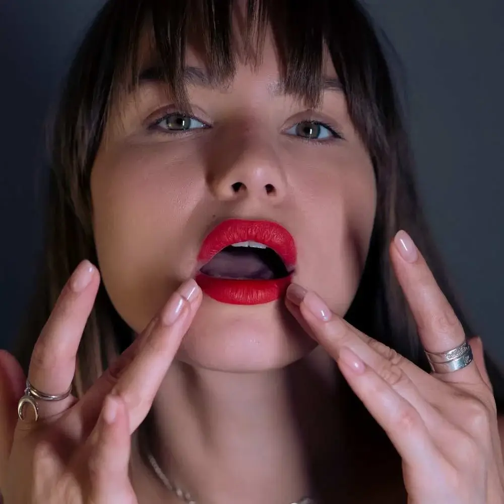 Close-up of an Asian woman's lips with a striking red lipstick