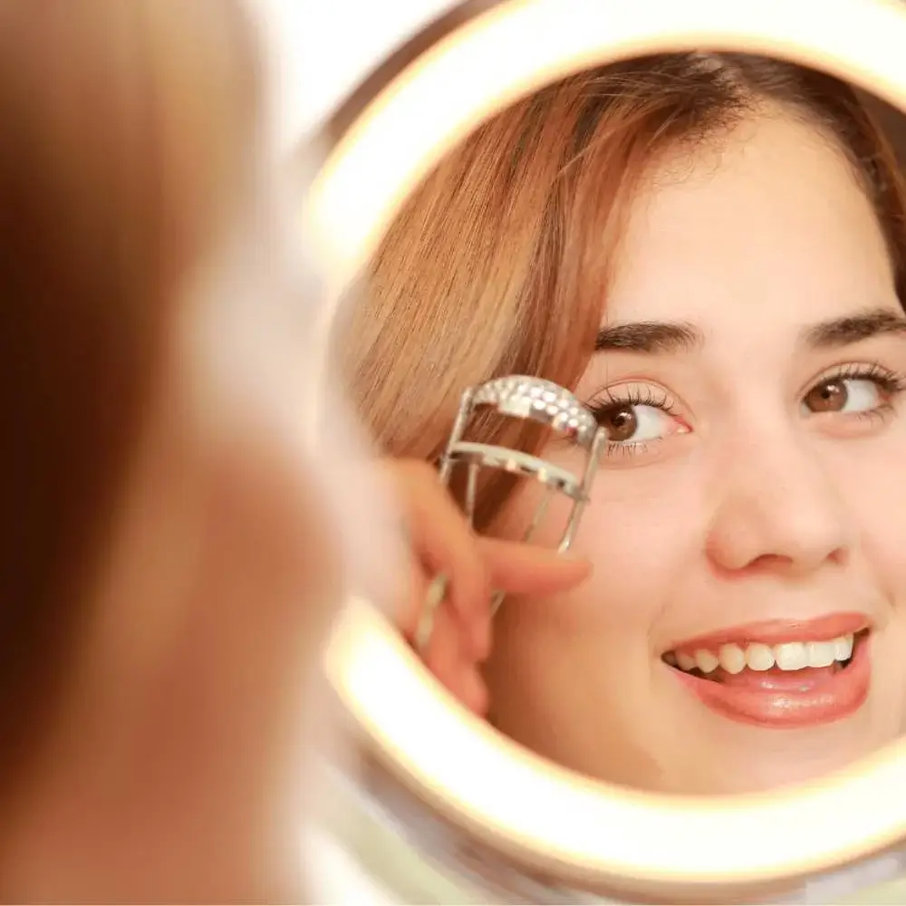 Woman flawlessly curling her eyelashes using a top-rated curler