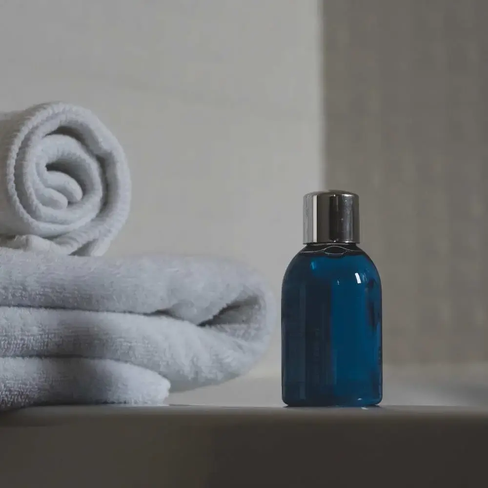 Image of a vibrant blue shampoo bottle on a white background