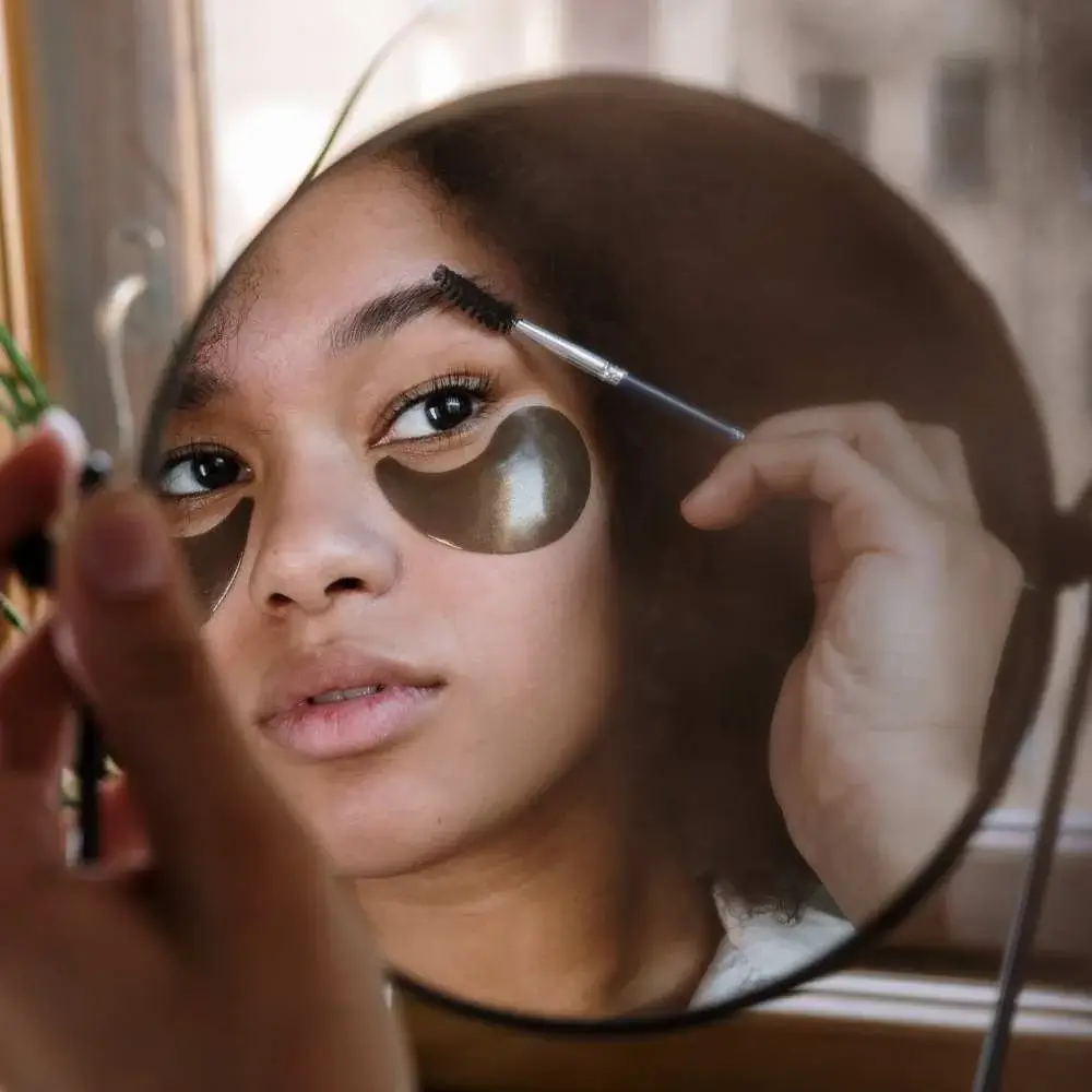 Beauty influencer shaping her brows with a creamy eyebrow pomade