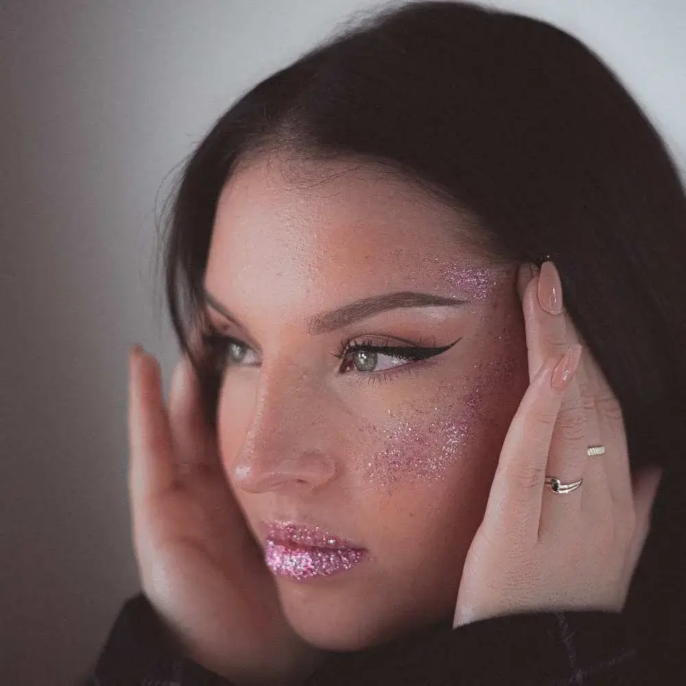 Woman with a glitter lipstick for a bold, festive look