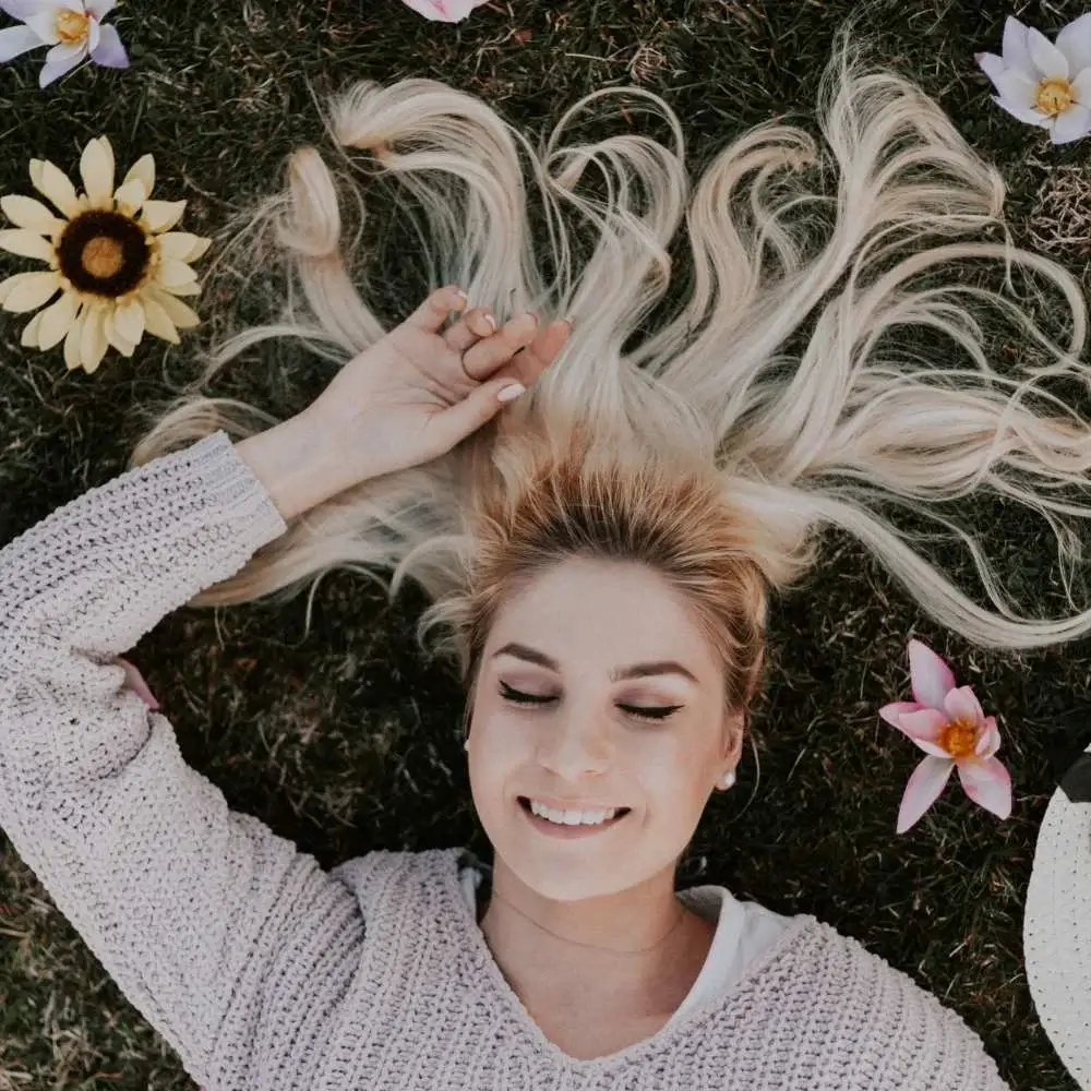 Woman with vibrant blonde hair showcasing the result of using blonde-specific shampoo