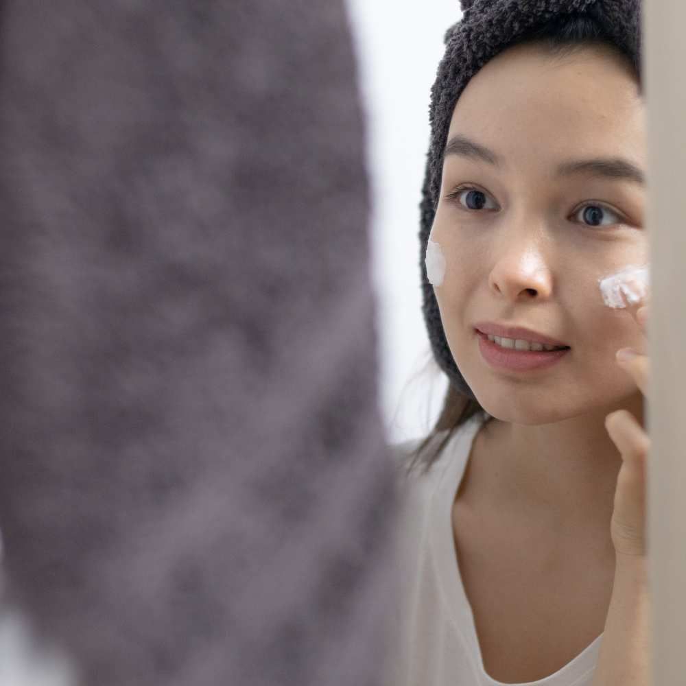 A woman's reflection, showcasing clear skin thanks to the best acne night cream