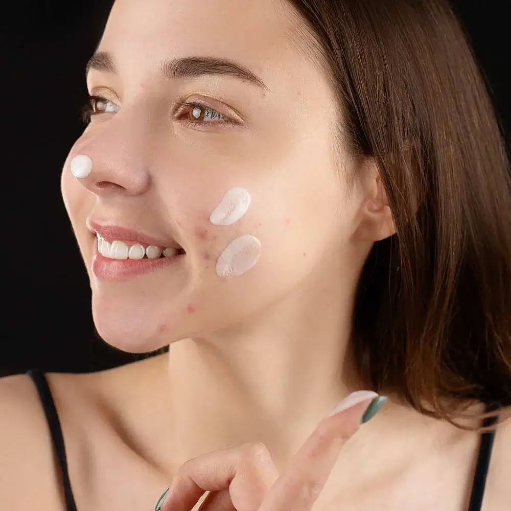  showcasing makeup application technique to hide acne