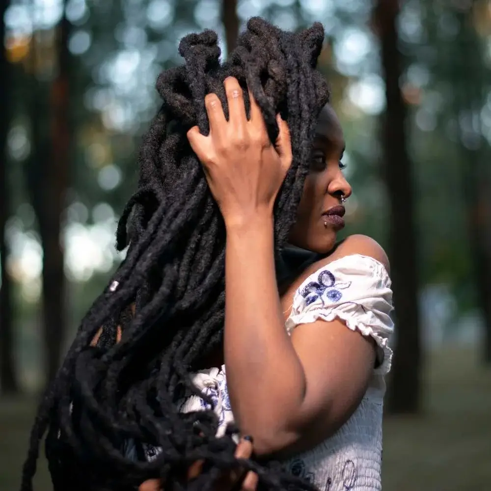 A person proudly showing off newly created dreadlocks