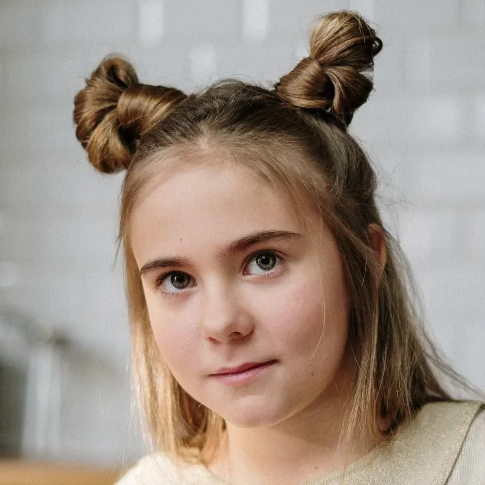 Adorable child sporting a neatly styled hair