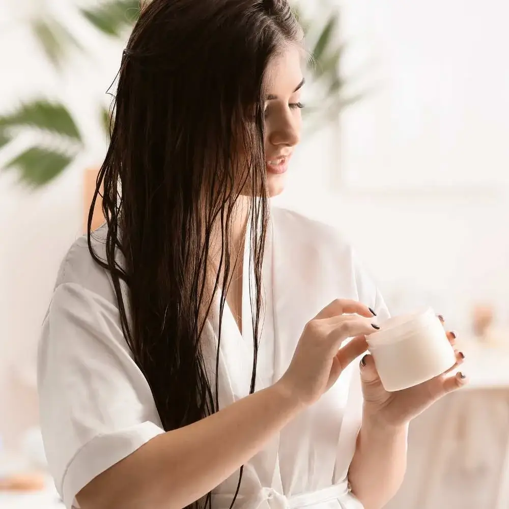 applying leave-in hair conditioner to enhance hair health