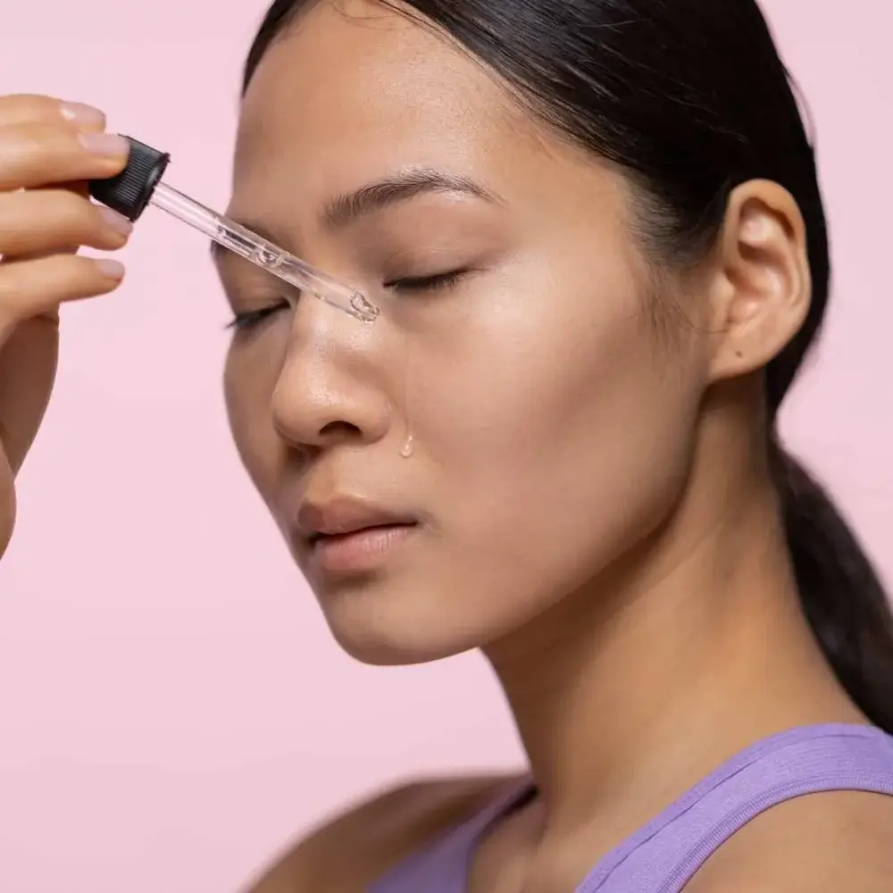 applying primer on acne-prone skin, showing improved texture