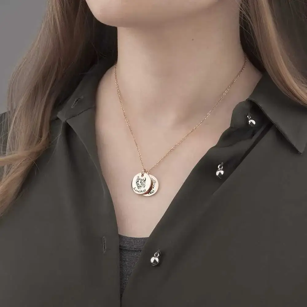 close-up view of a woman's neck with a portrait necklace of her pets