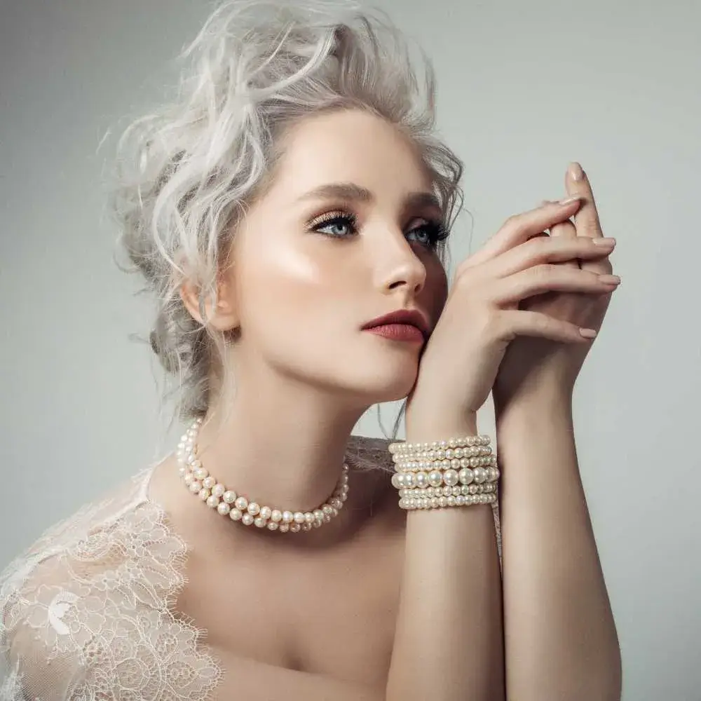 portrait of a beautiful woman with wearing pearl necklace and pearl bracelets