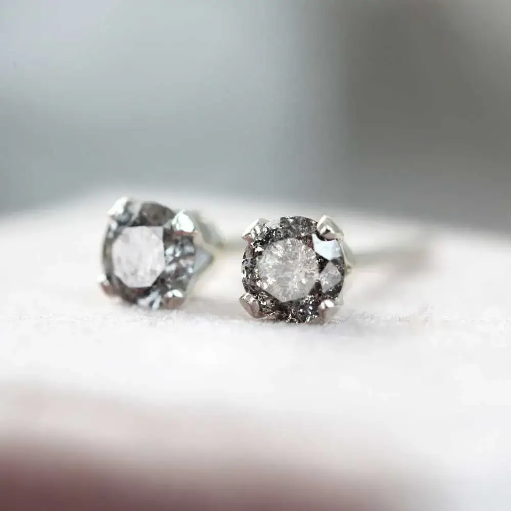 salt and pepper diamond earrings on a white background
