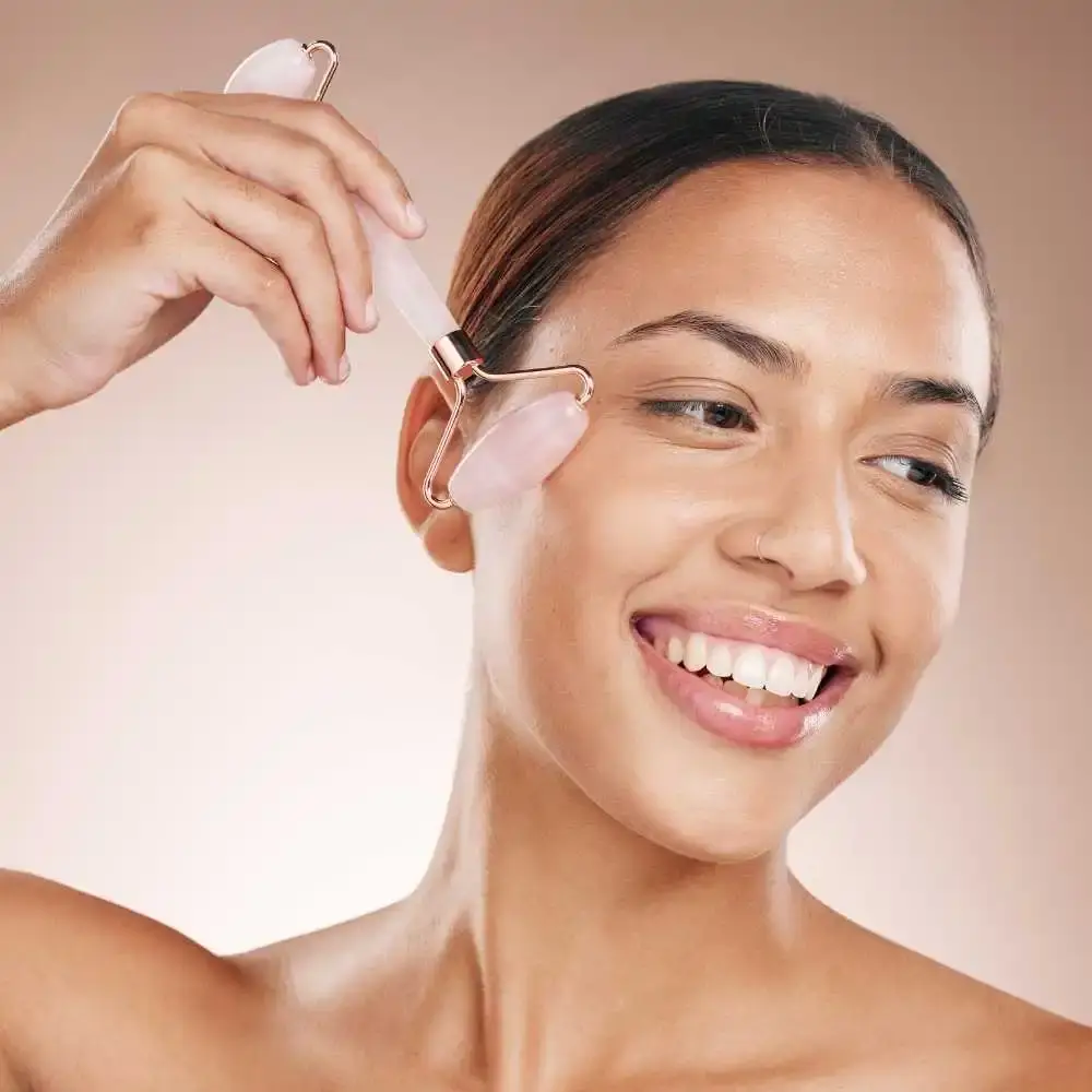 closeup portrait of a woman using a rose quartz roller