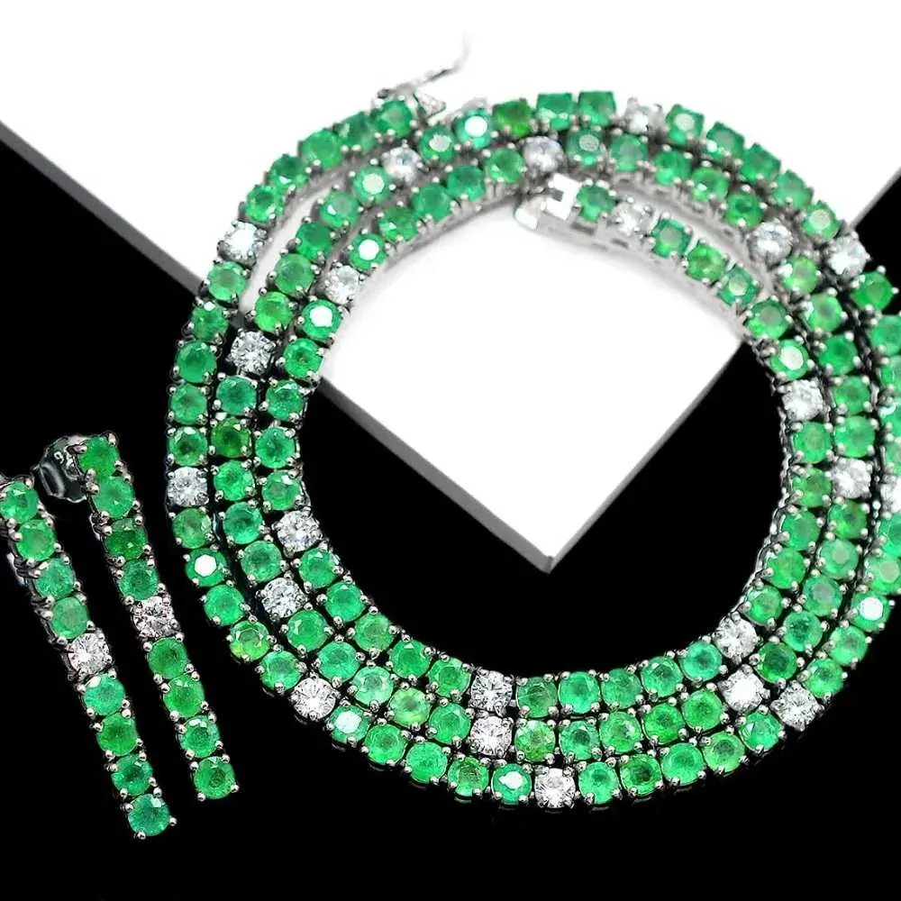  emerald tennis necklace on a black and white background