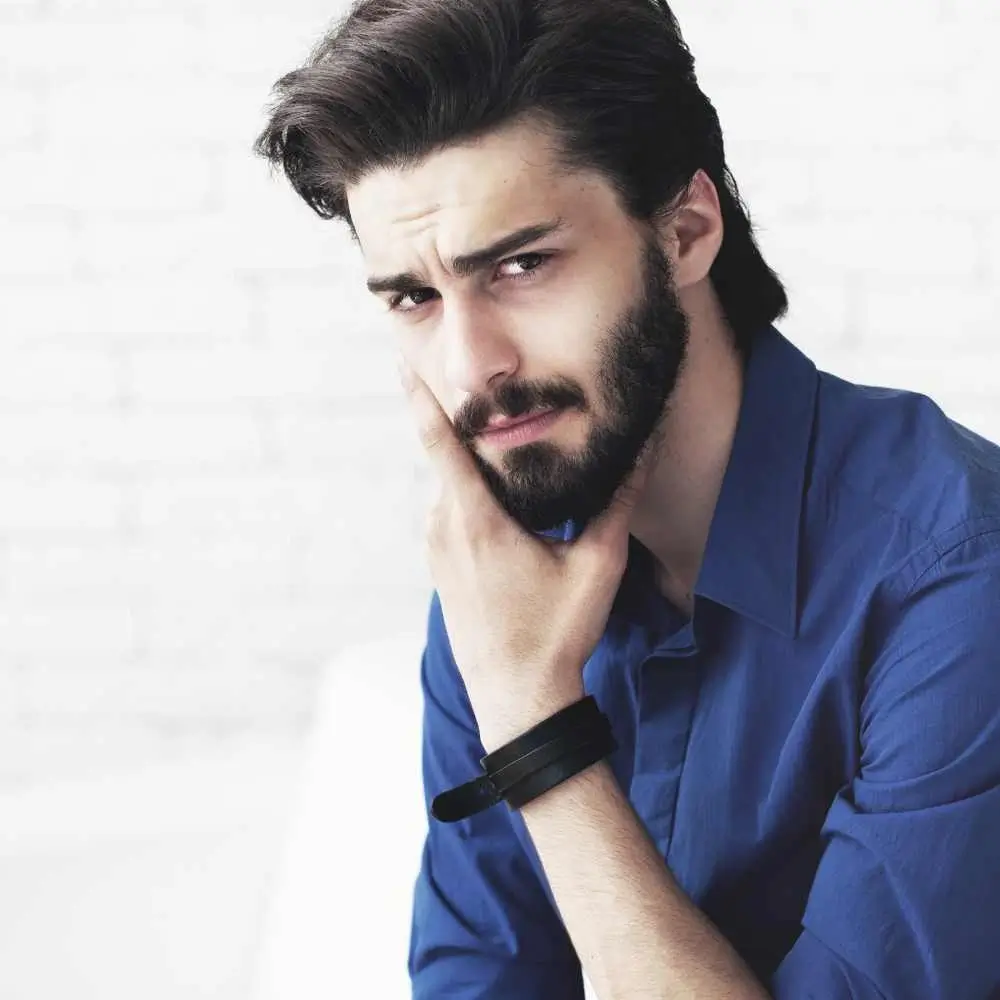 young bearded man in a blue shirt