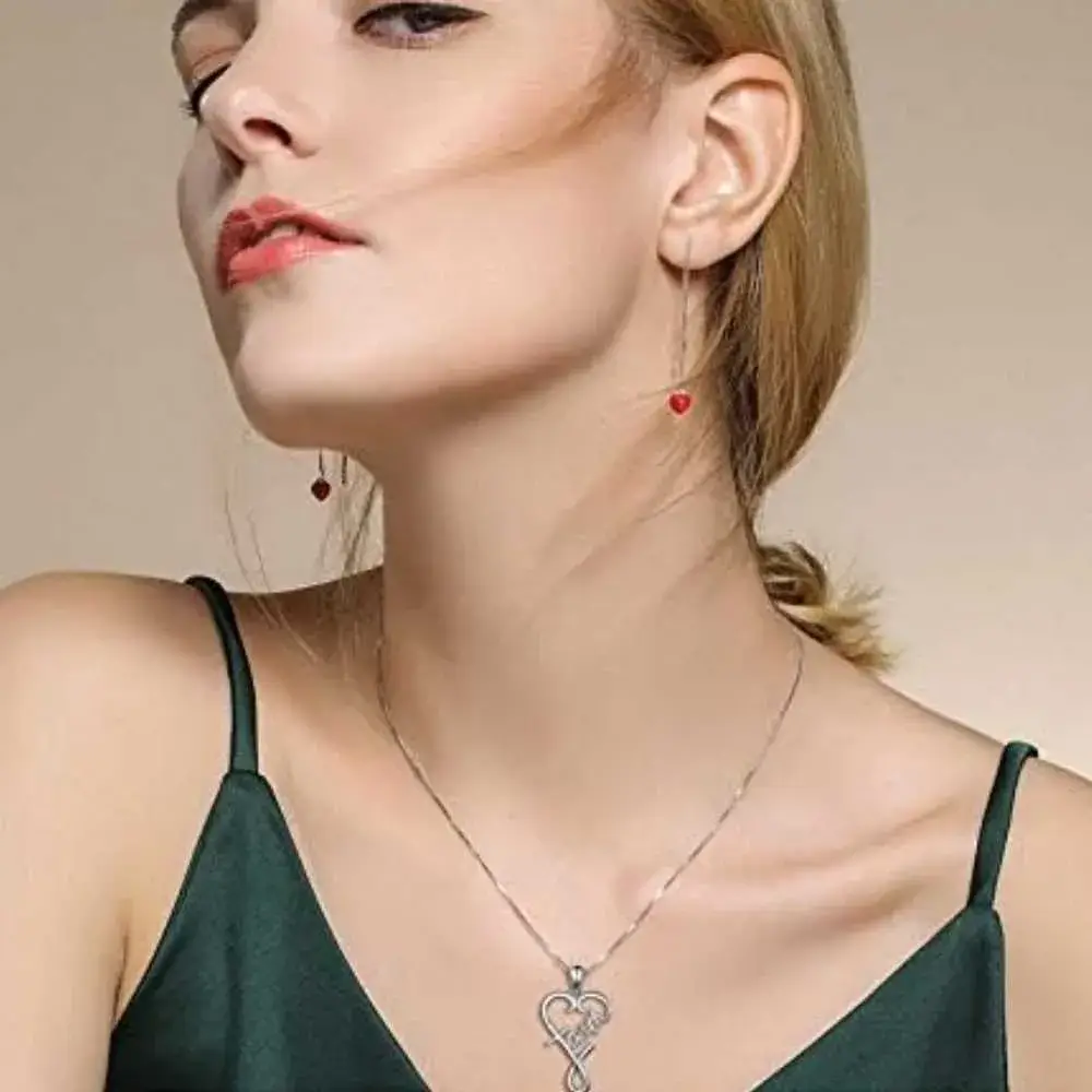 young woman in an emerald green dress wearing faith over fear necklace
