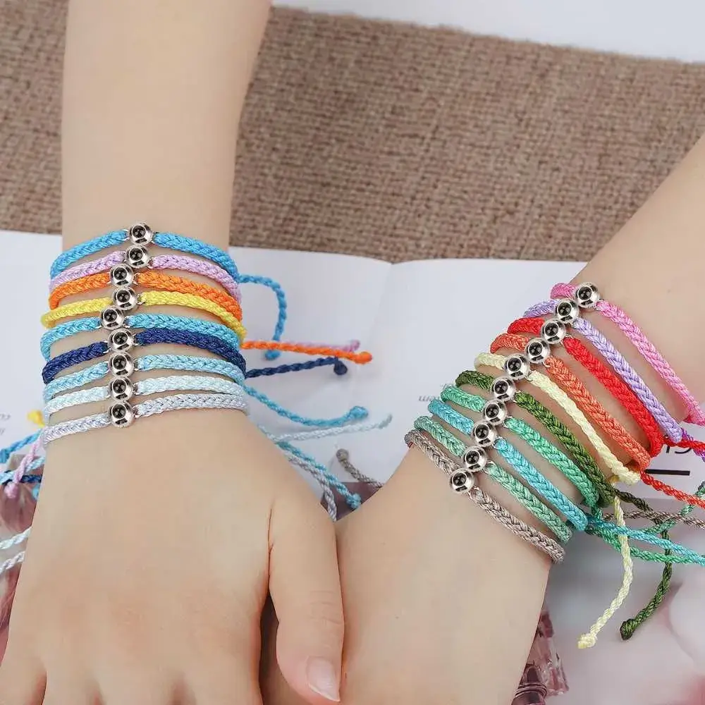 different colors of photo projection bracelets on the right and left wrists