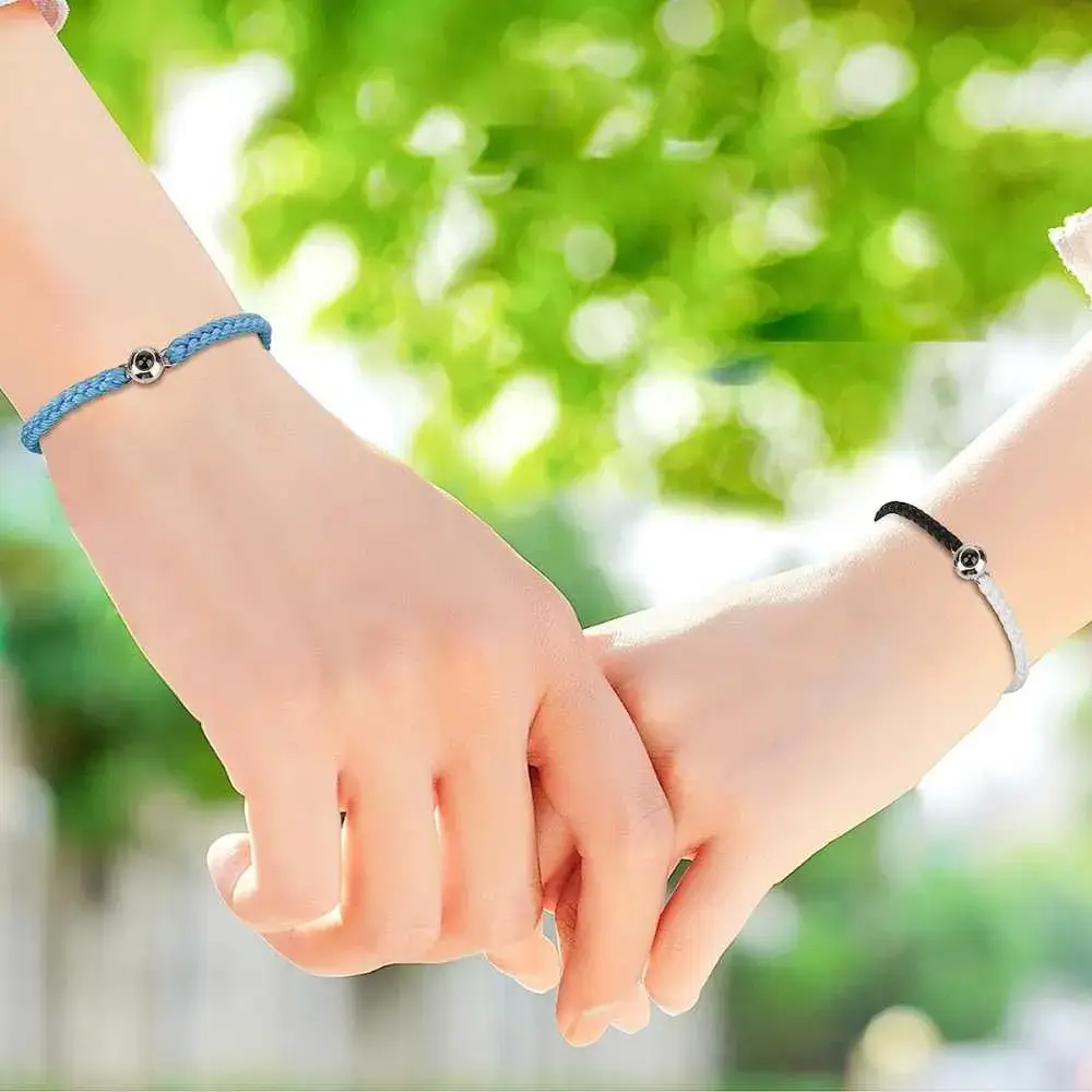 two wrists with photo projection bracelets