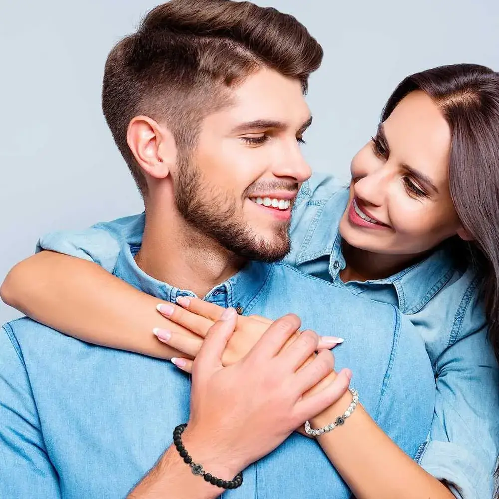 couple in denim shirts wearing photo projection bracelets