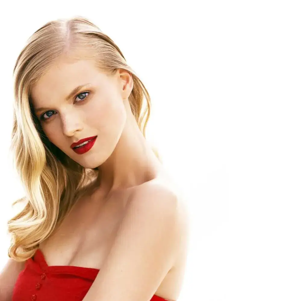 portrait of young blonde woman wearing red dress and red lipstick