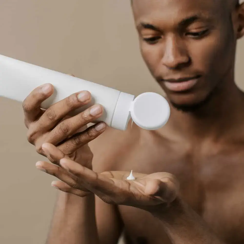 young man holding a moisturizer