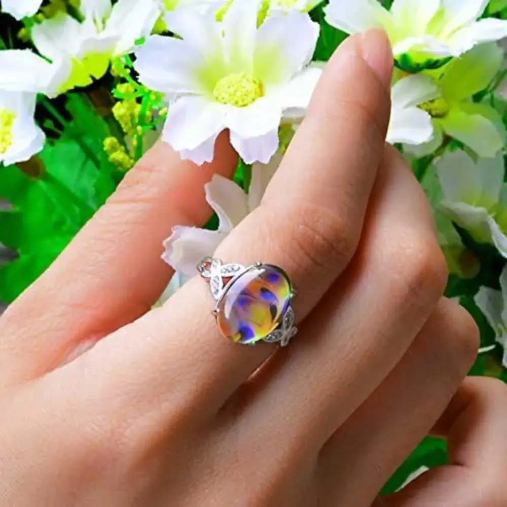 close-up view of a hand with color changing ring holding white flowers