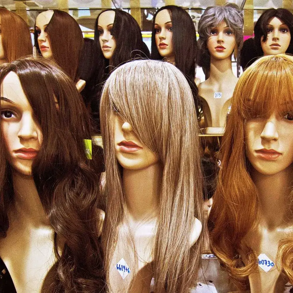 different colors and hairstyles of human hair wigs on the shelf