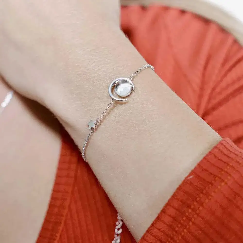 close-up view of a woman's wrist with real moon dust meteorite bracelet