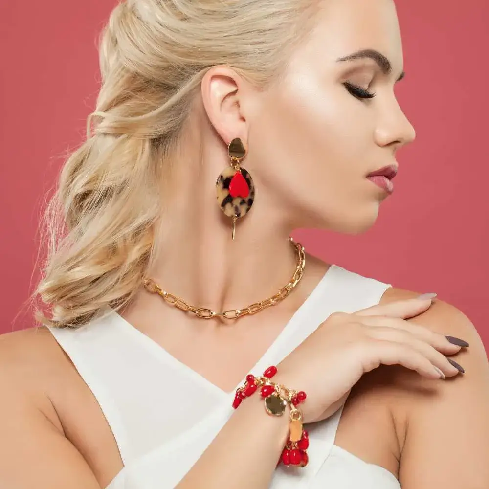 closeup side view portrait of a blonde woman wearing golden chain necklace