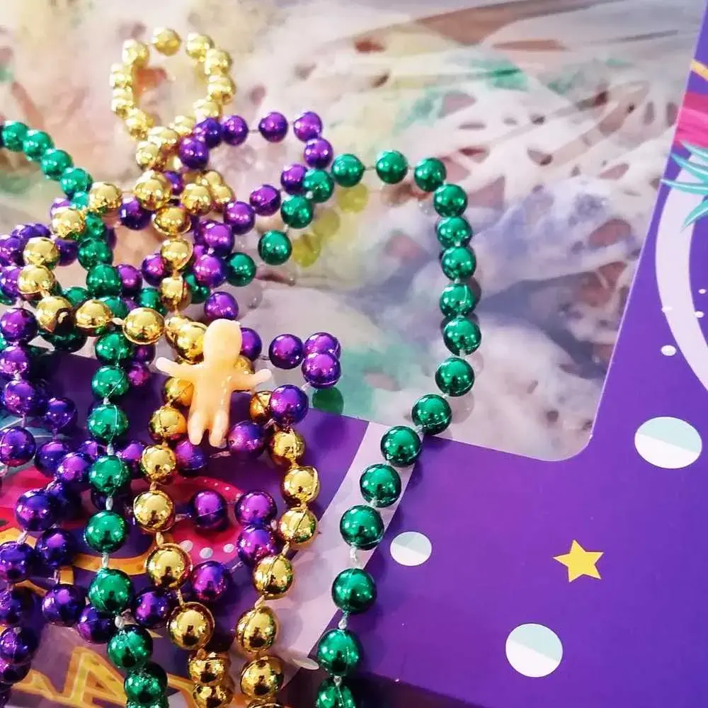 mardi gras necklace with a small plastic baby
