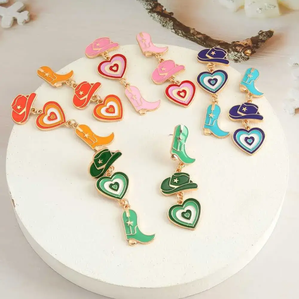 different colors of enamel cowgirl boots and hat earrings with a heart