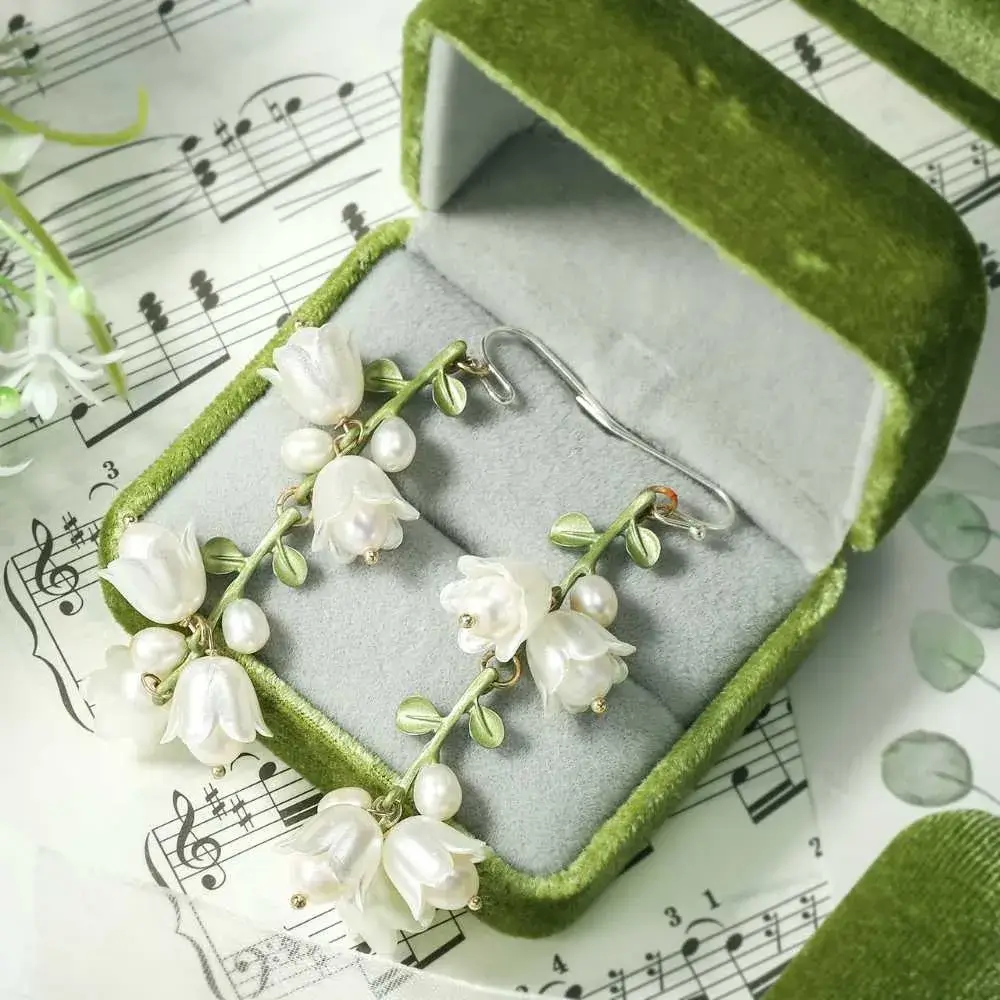 lily of the valley earrings in a green jewelry box