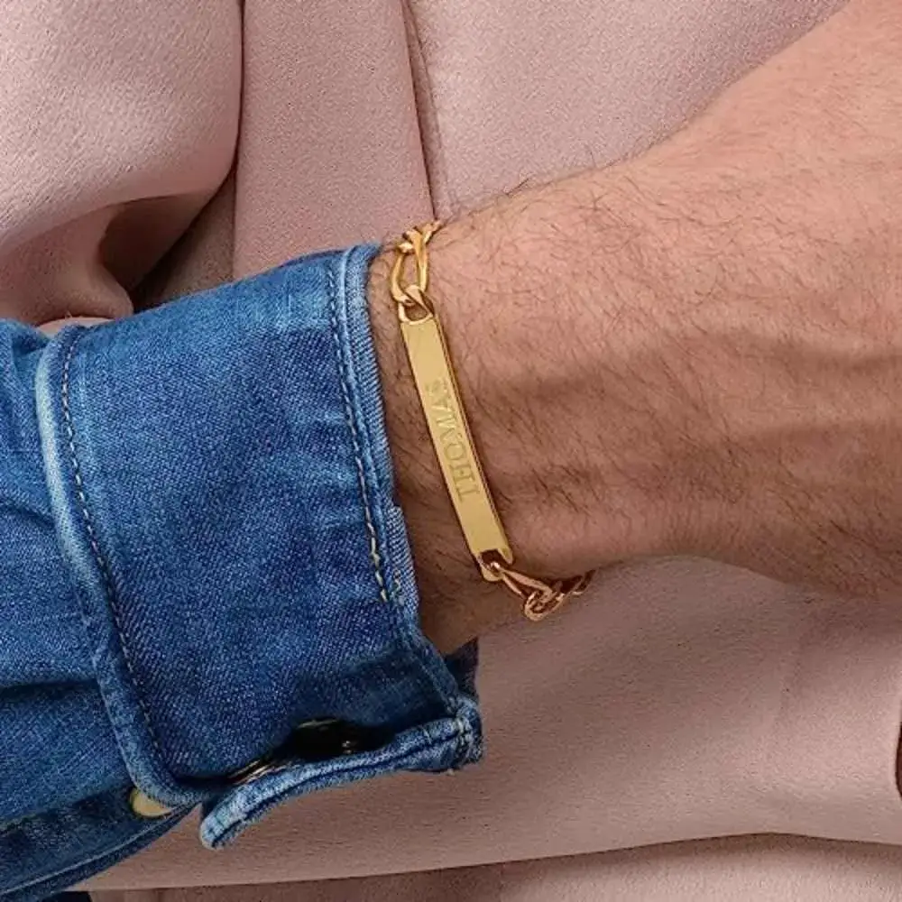 close-up of a man's wrist with gold esclava bracelet