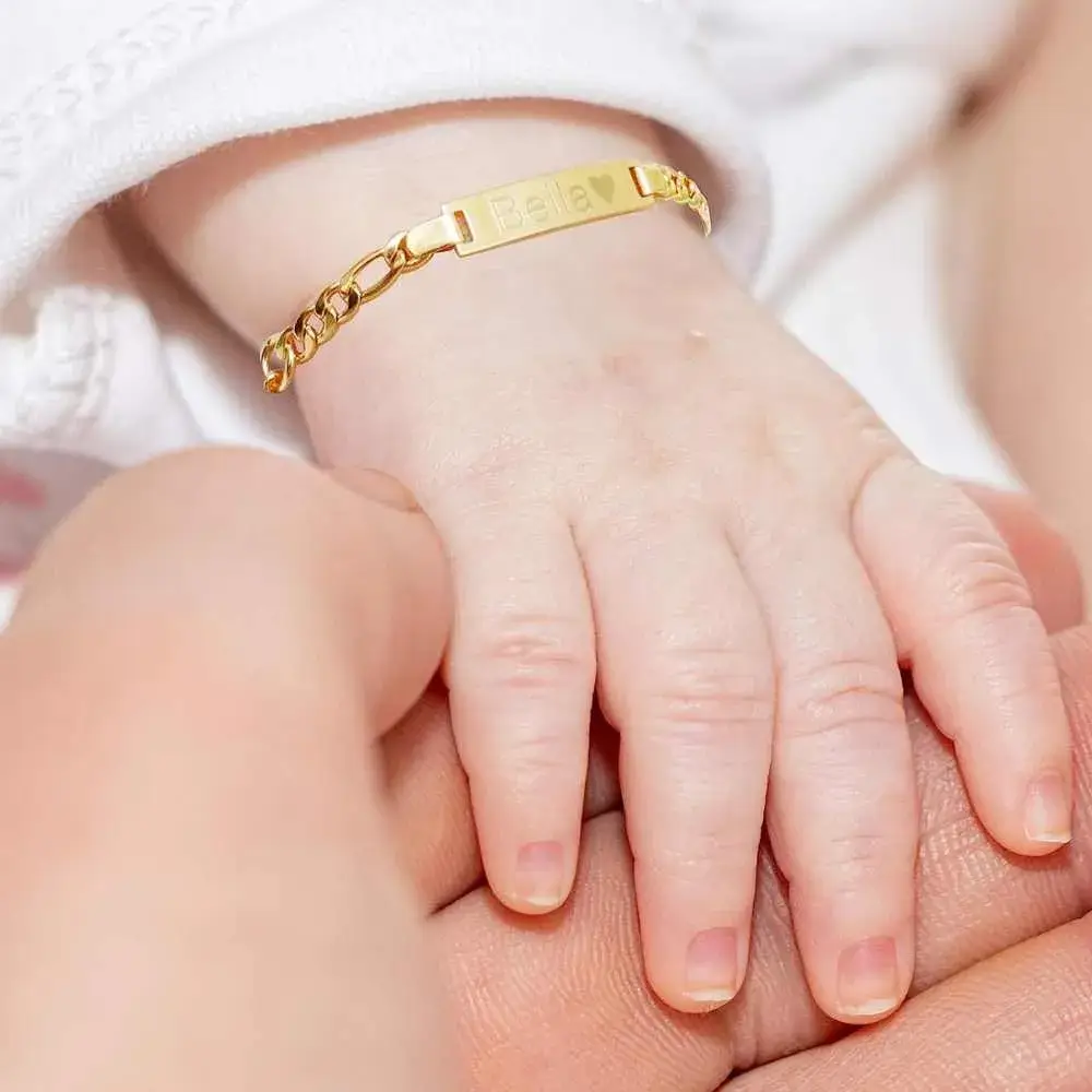 close-up view of a baby's wrist with personalized gold esclava bracelet