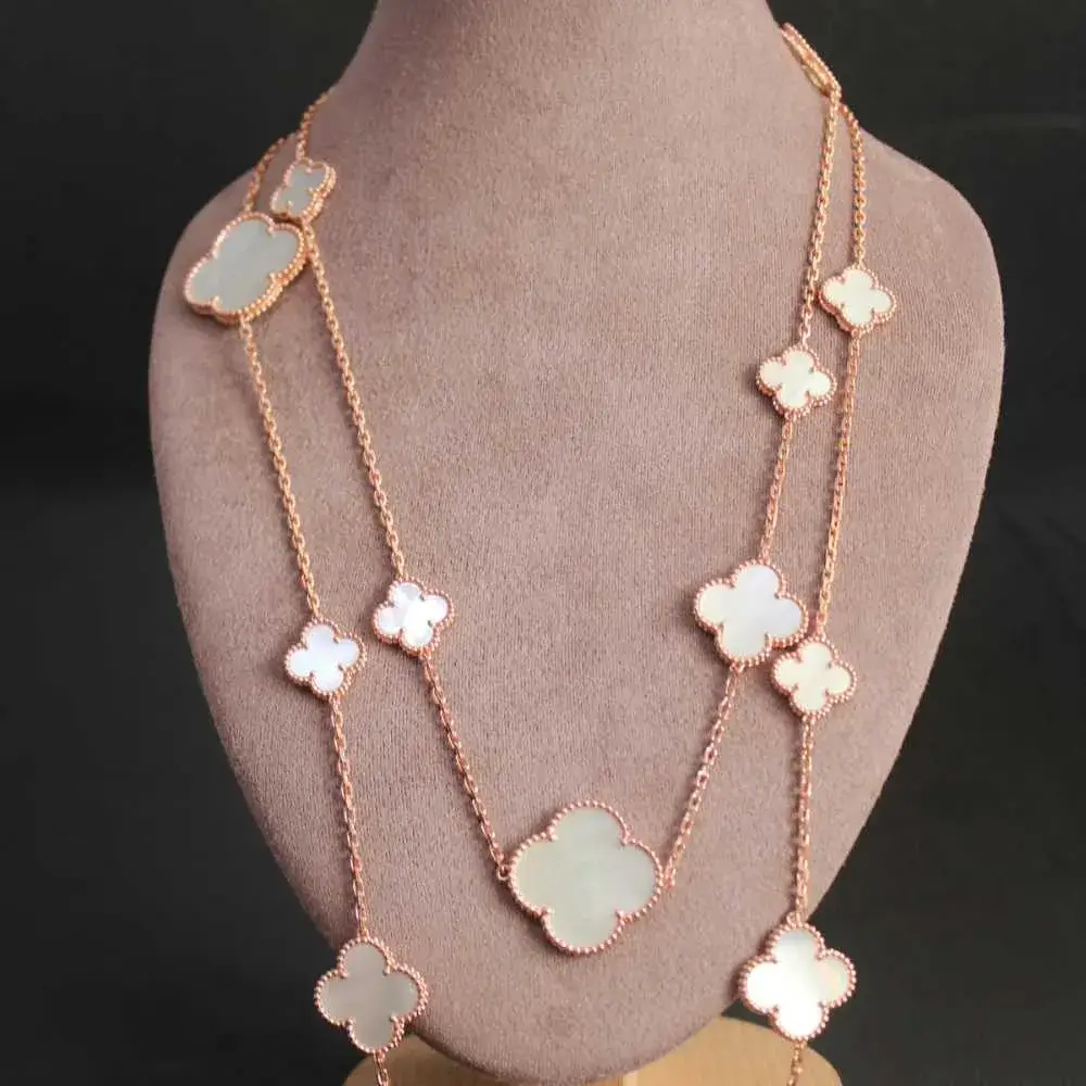 gold mother of clover pearl necklace on a mannequin neck jewelry holder