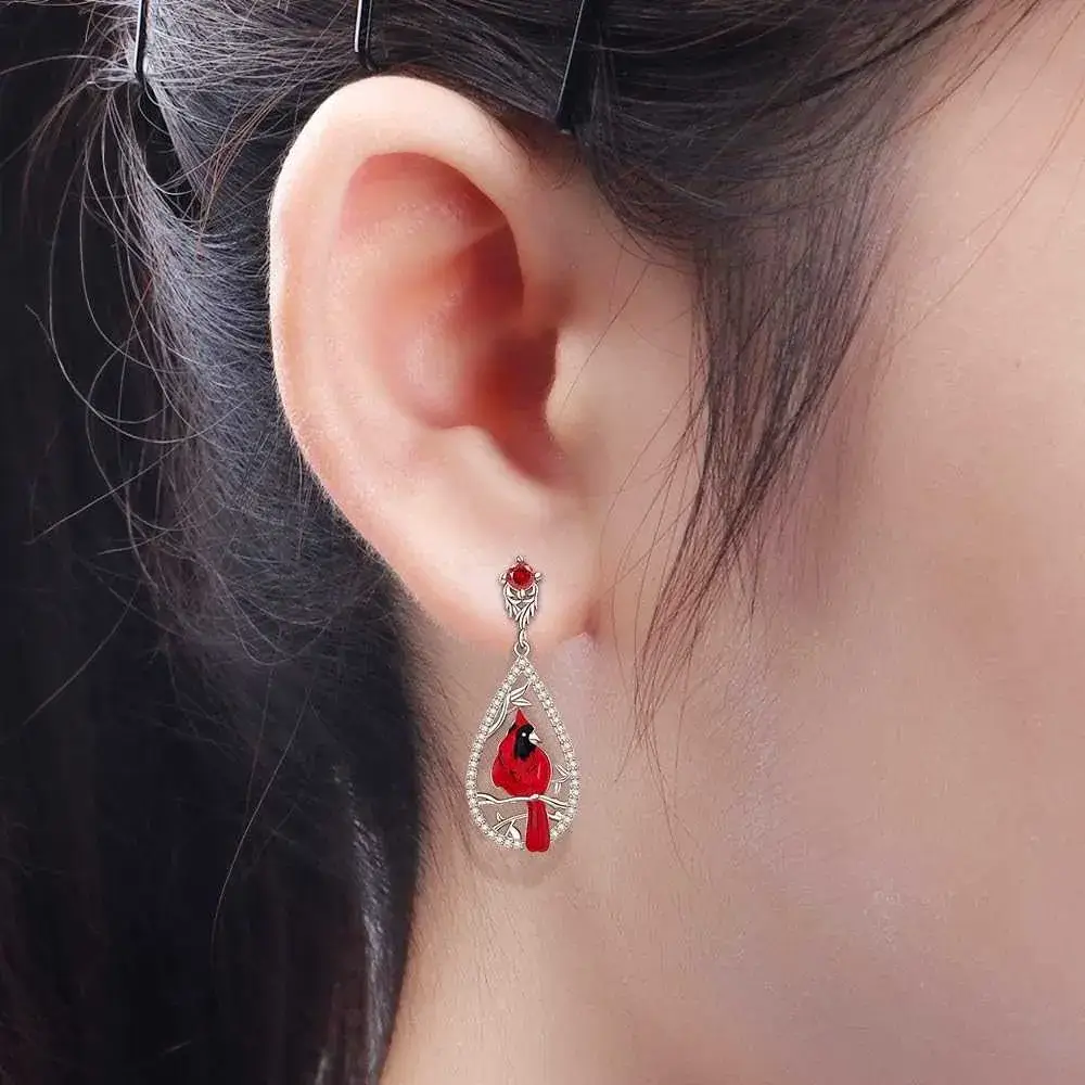 close-up view of  a girl's ear with silver cardinal earring