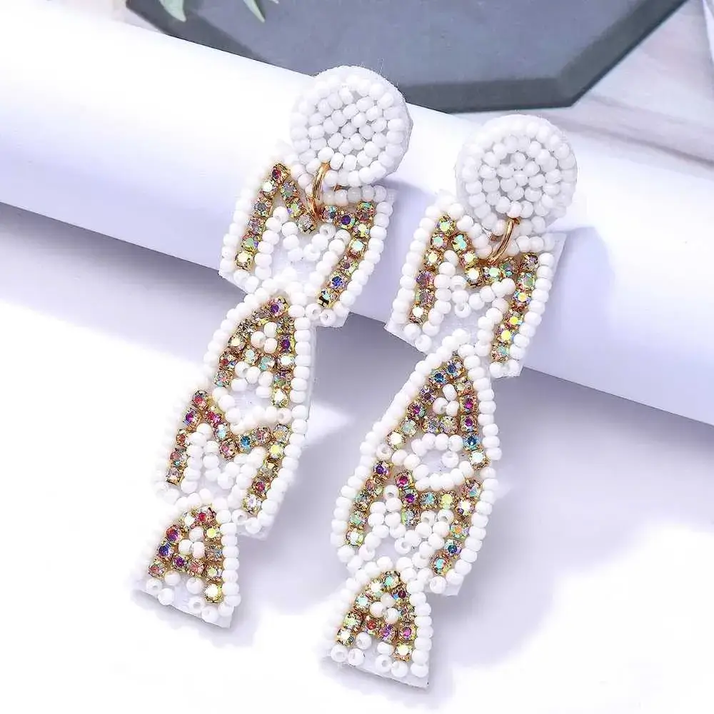 pair of white mama earrings with colorful crystals