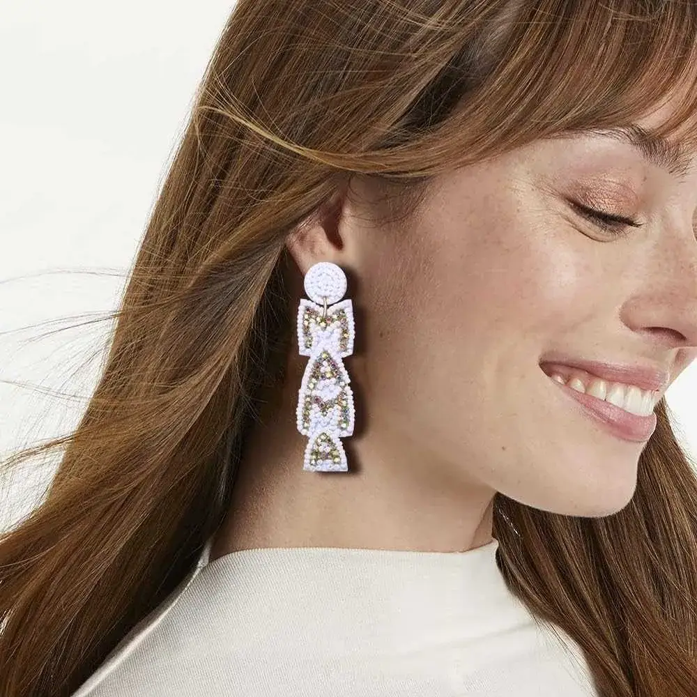 close-up portrait of a brunette woman smiling with mama earrings