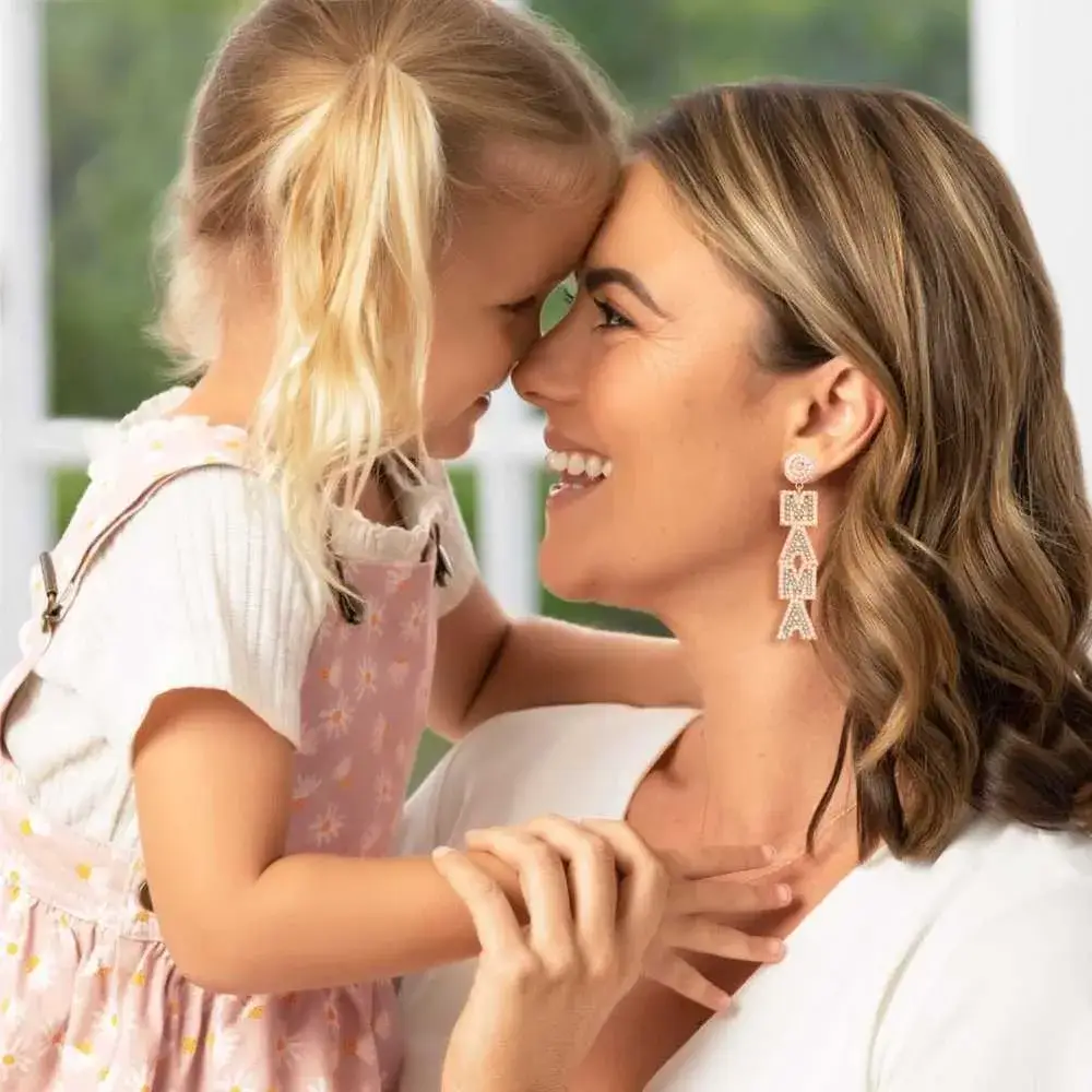 woman wearing a mama earring with her daughter